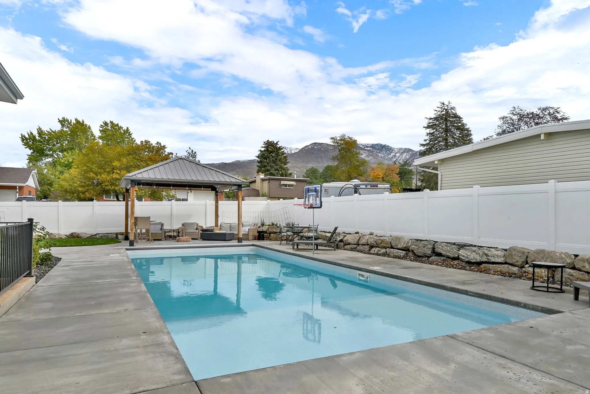 View of pool featuring a gazebo, a patio, a mountain view, and a fenced backyard