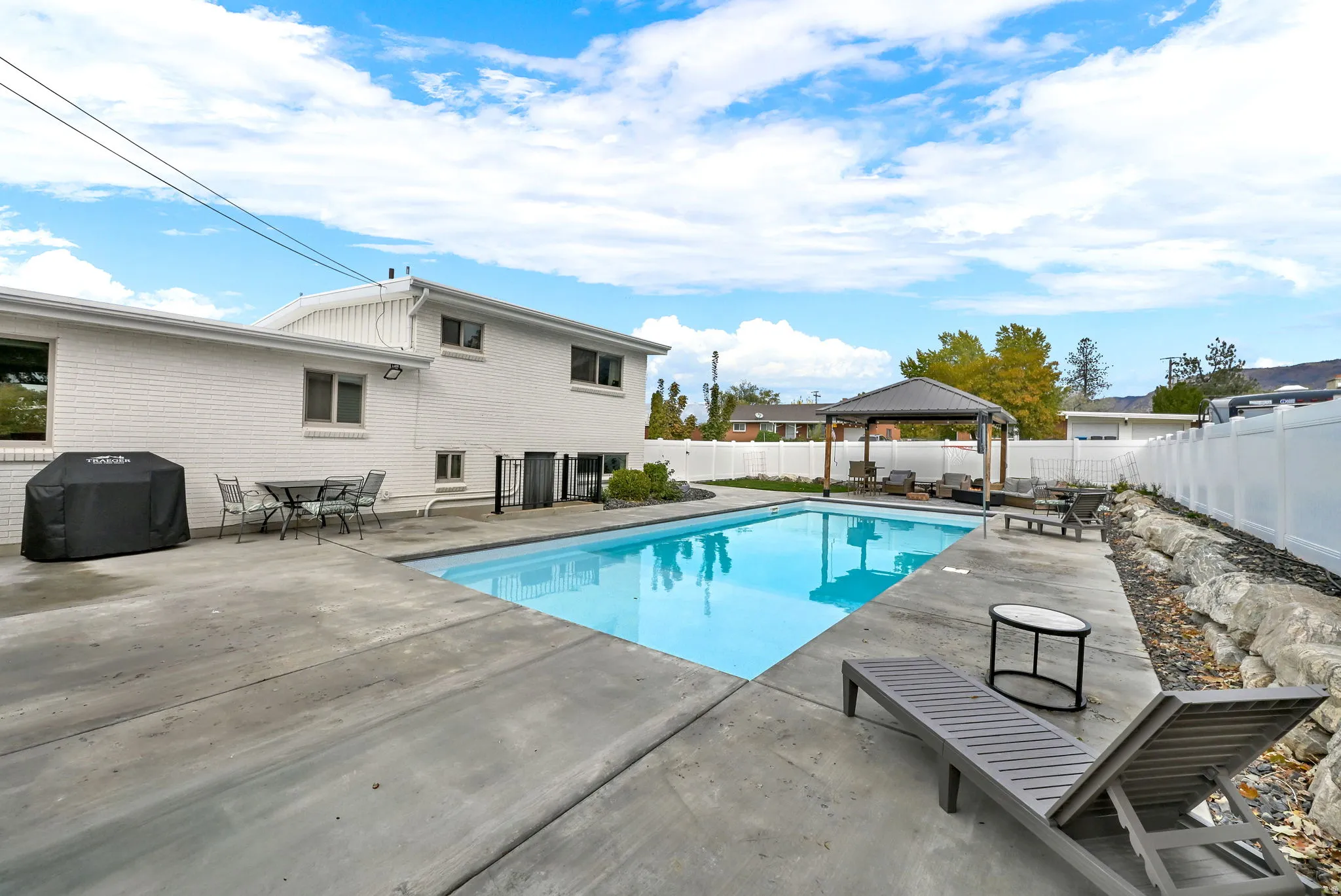 View of pool featuring a patio area, a gazebo, and outdoor dining space