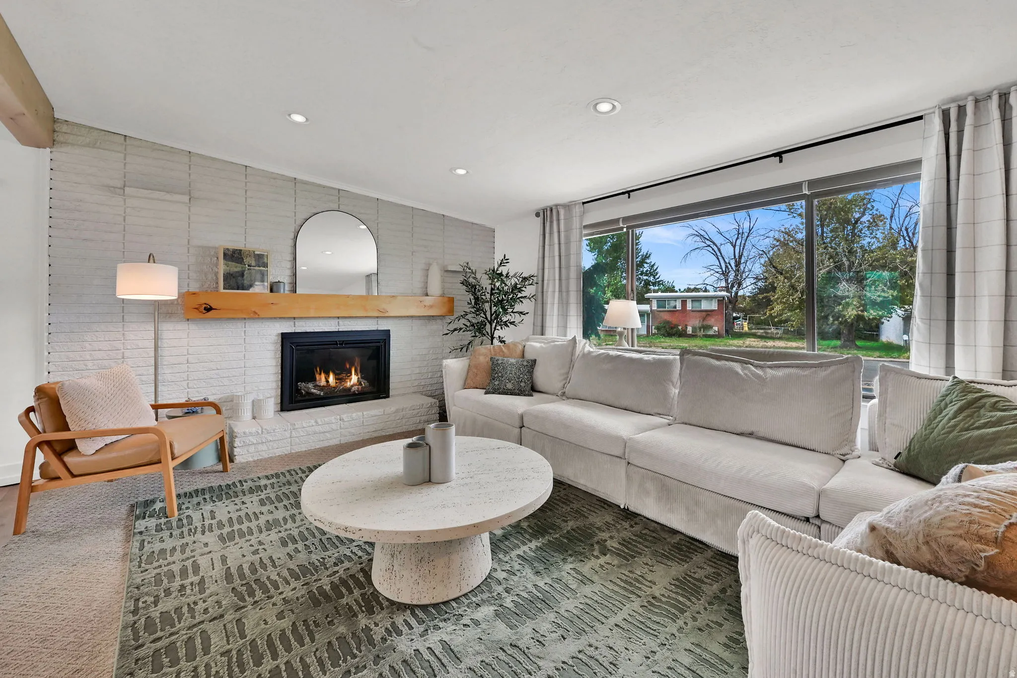 Living room featuring a brick fireplace and recessed lighting