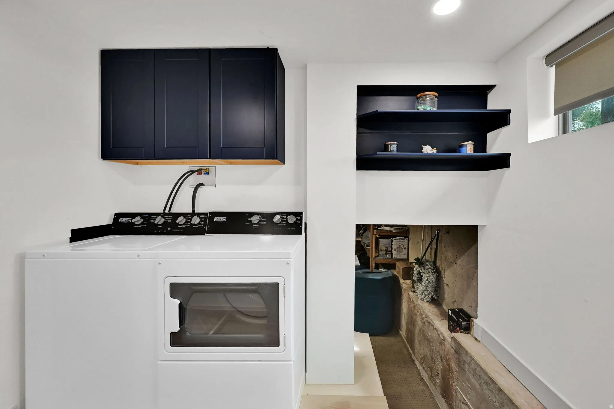 Laundry room featuring cabinet space, washer and dryer, and recessed lighting