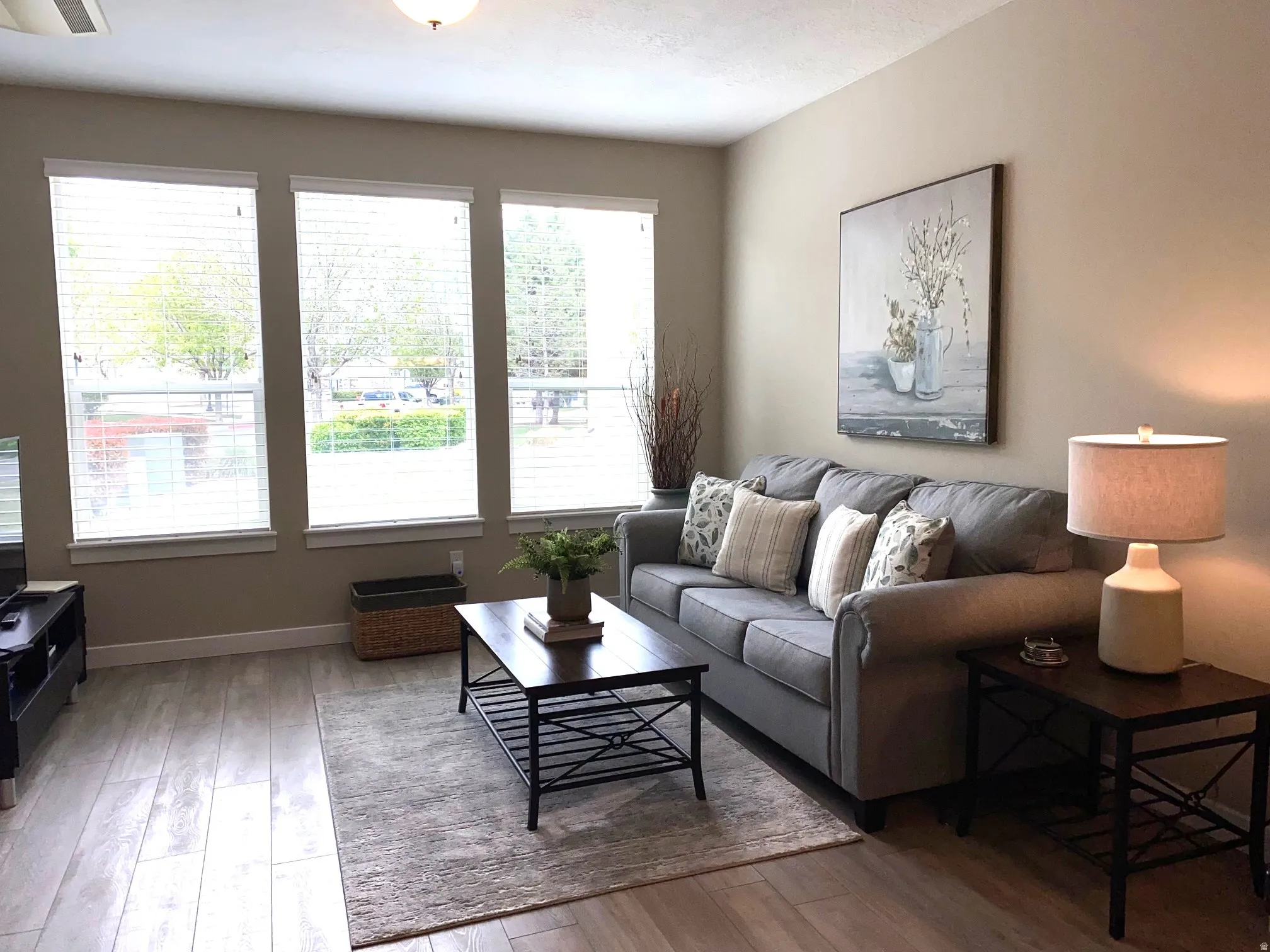 Living area with light wood-style floors and baseboards