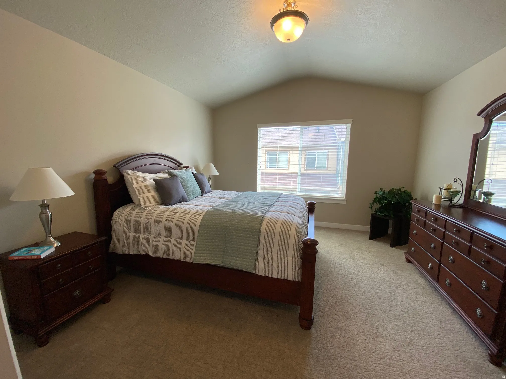 Bedroom with carpet floors and a textured ceiling