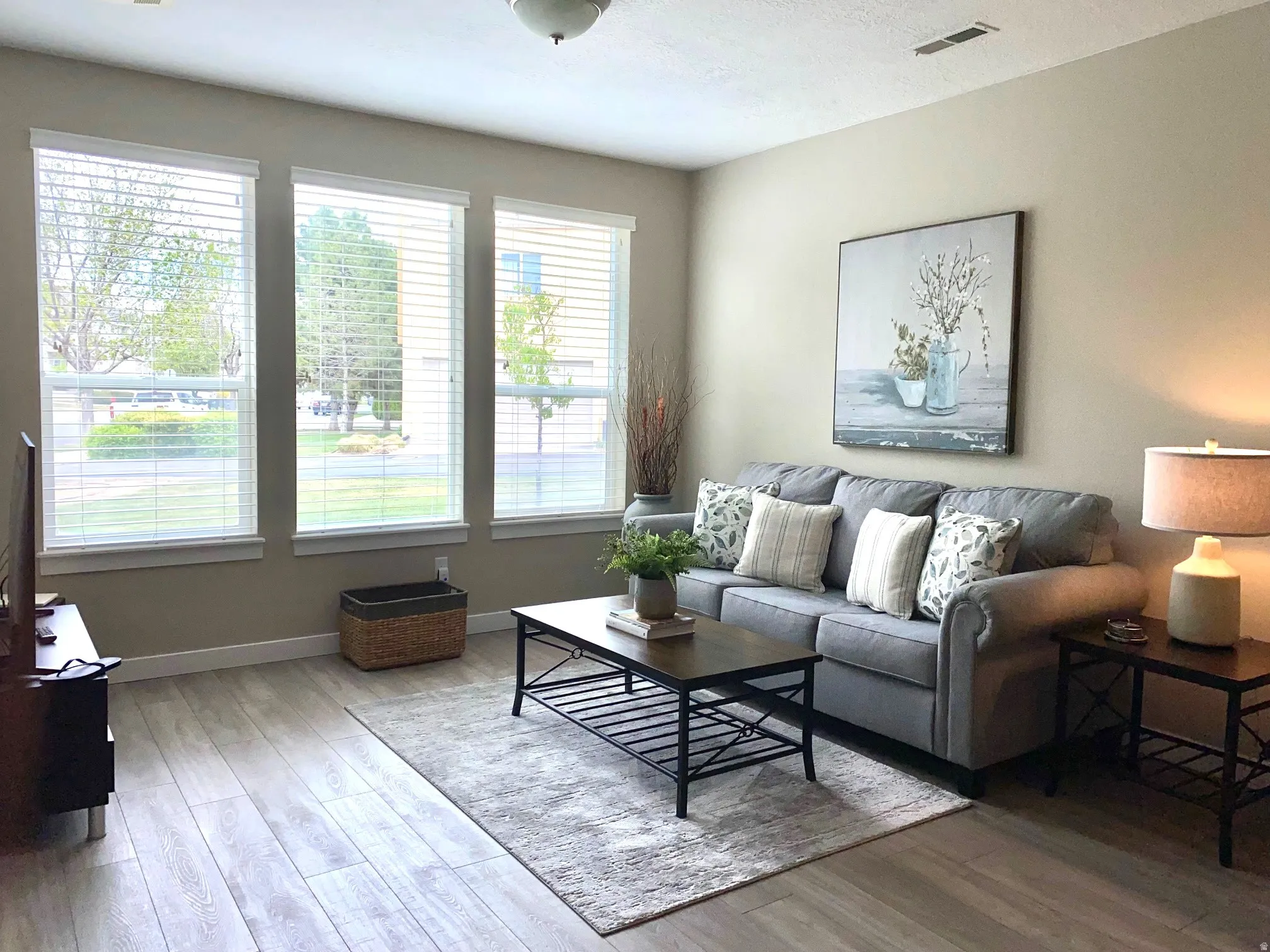 Living area featuring light wood-style floors and baseboards