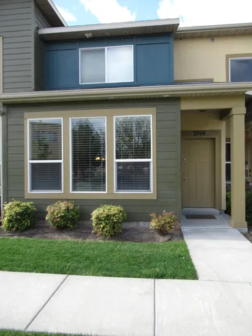 View of exterior entry with a lawn