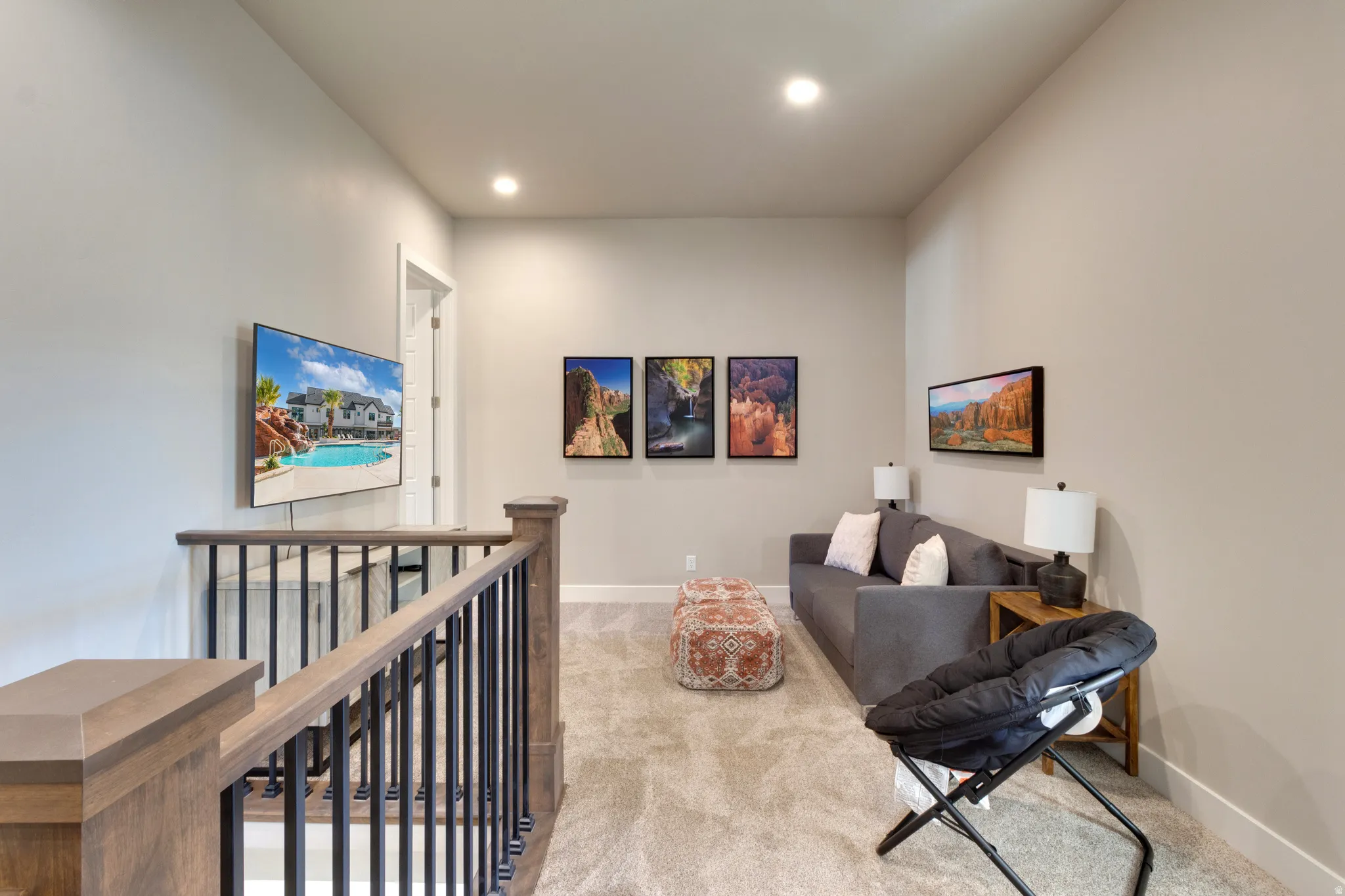 Sitting room featuring an upstairs landing, carpet, and recessed lighting