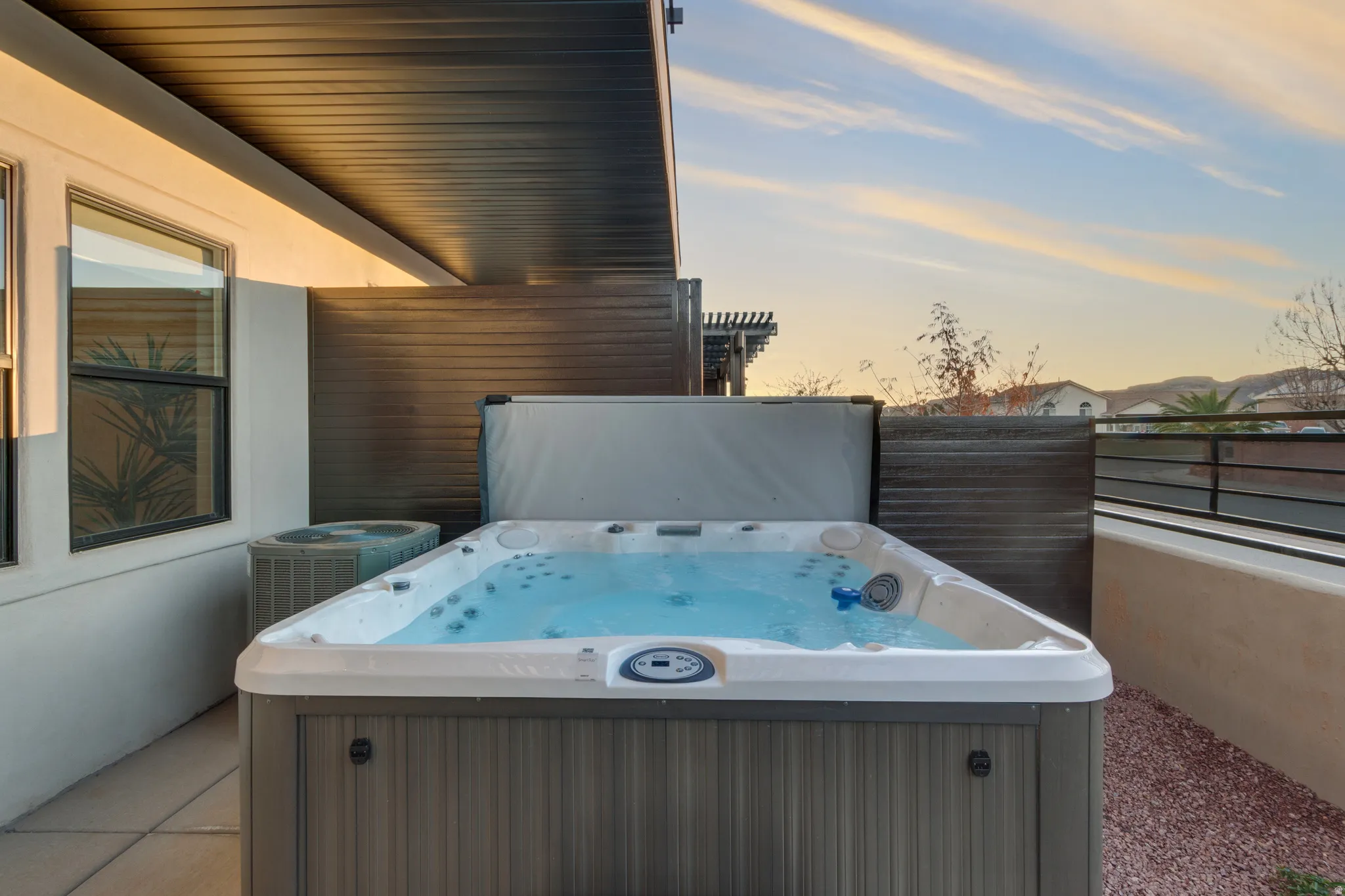 View of patio with a hot tub