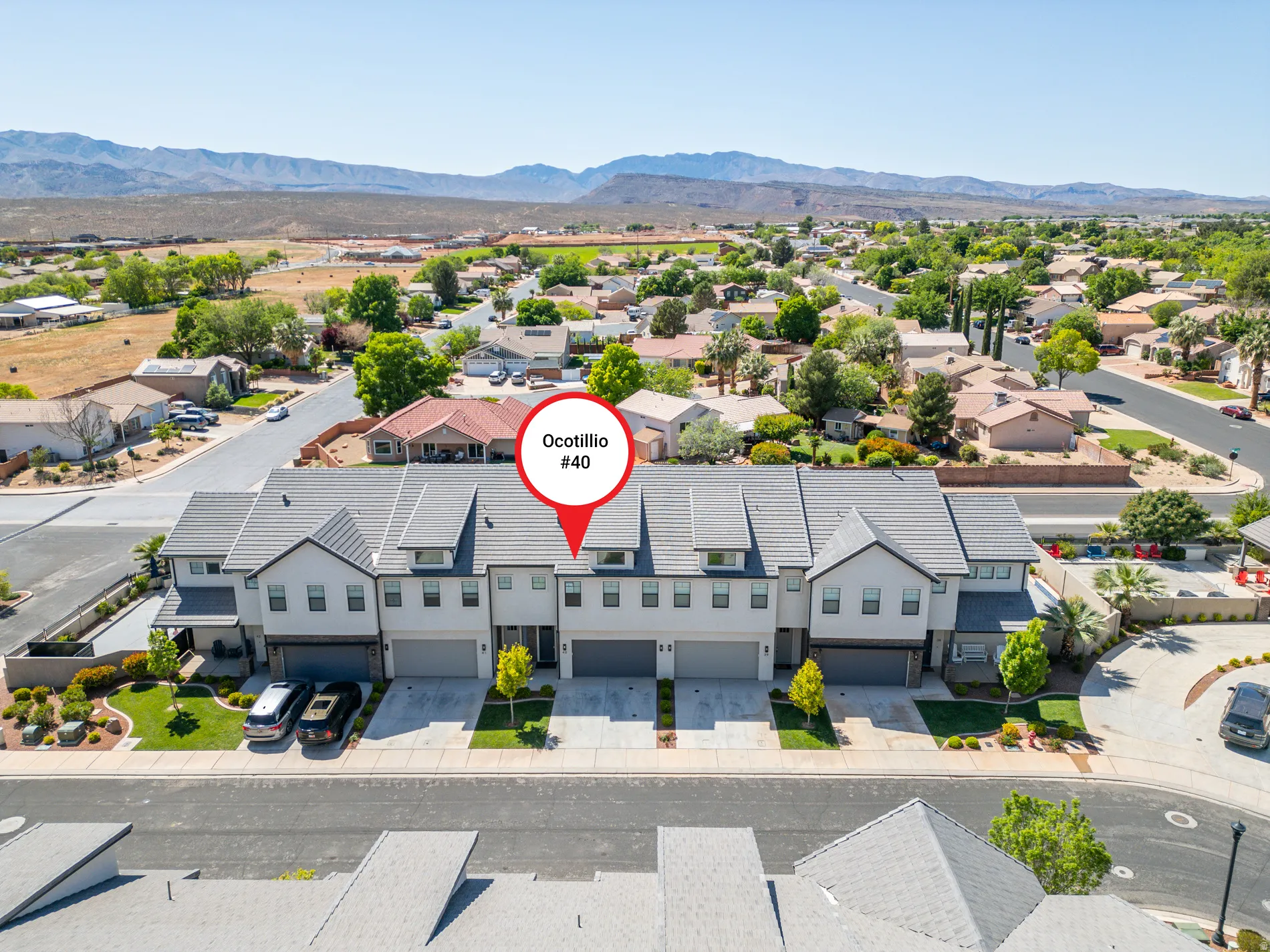 Aerial view of residential area featuring a mountain backdrop