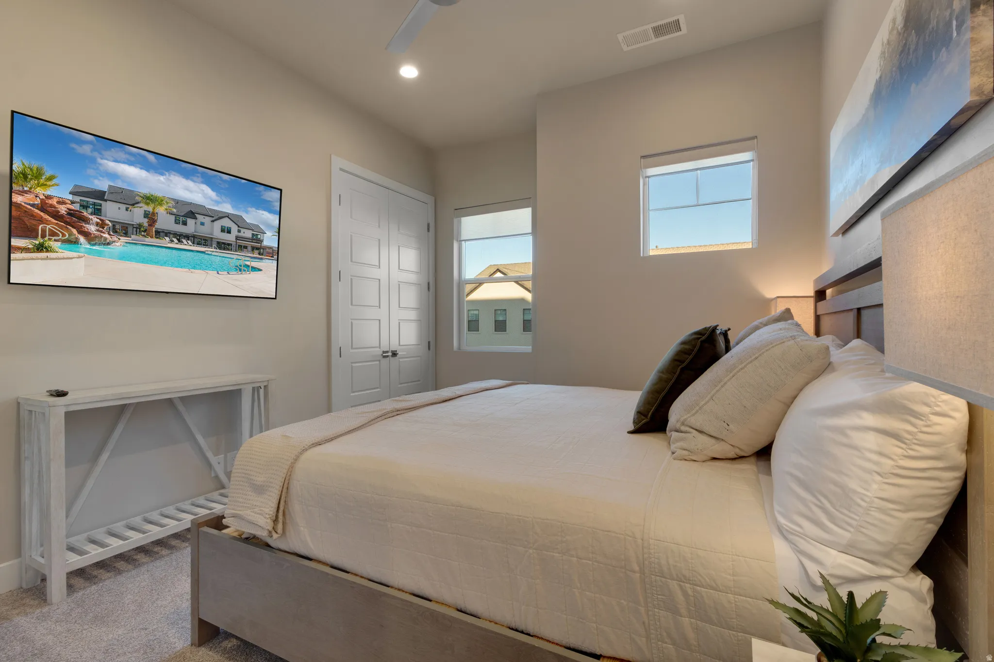 Carpeted bedroom featuring a ceiling fan, recessed lighting, and a closet