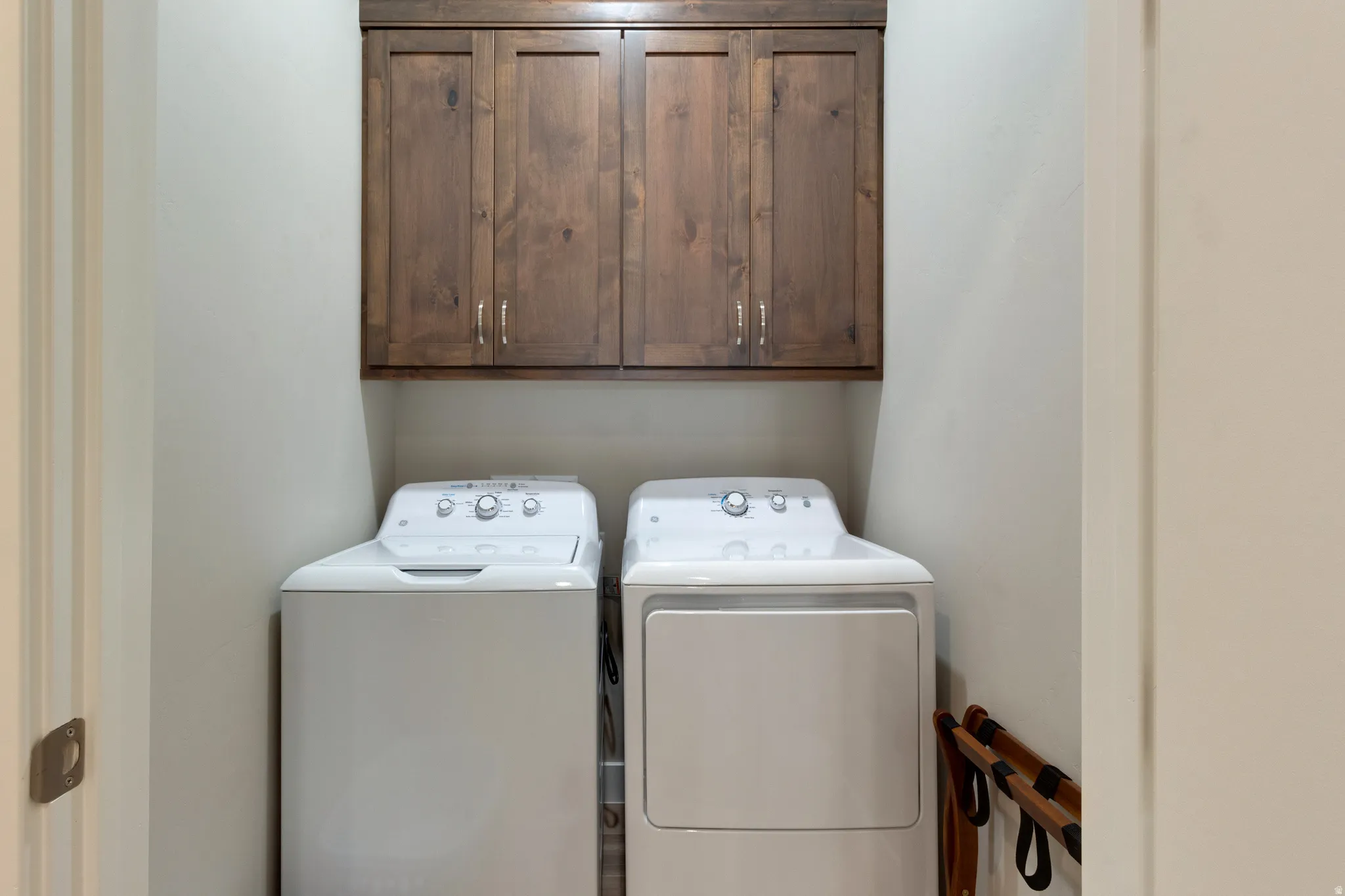 Laundry area featuring cabinet space and separate washer and dryer