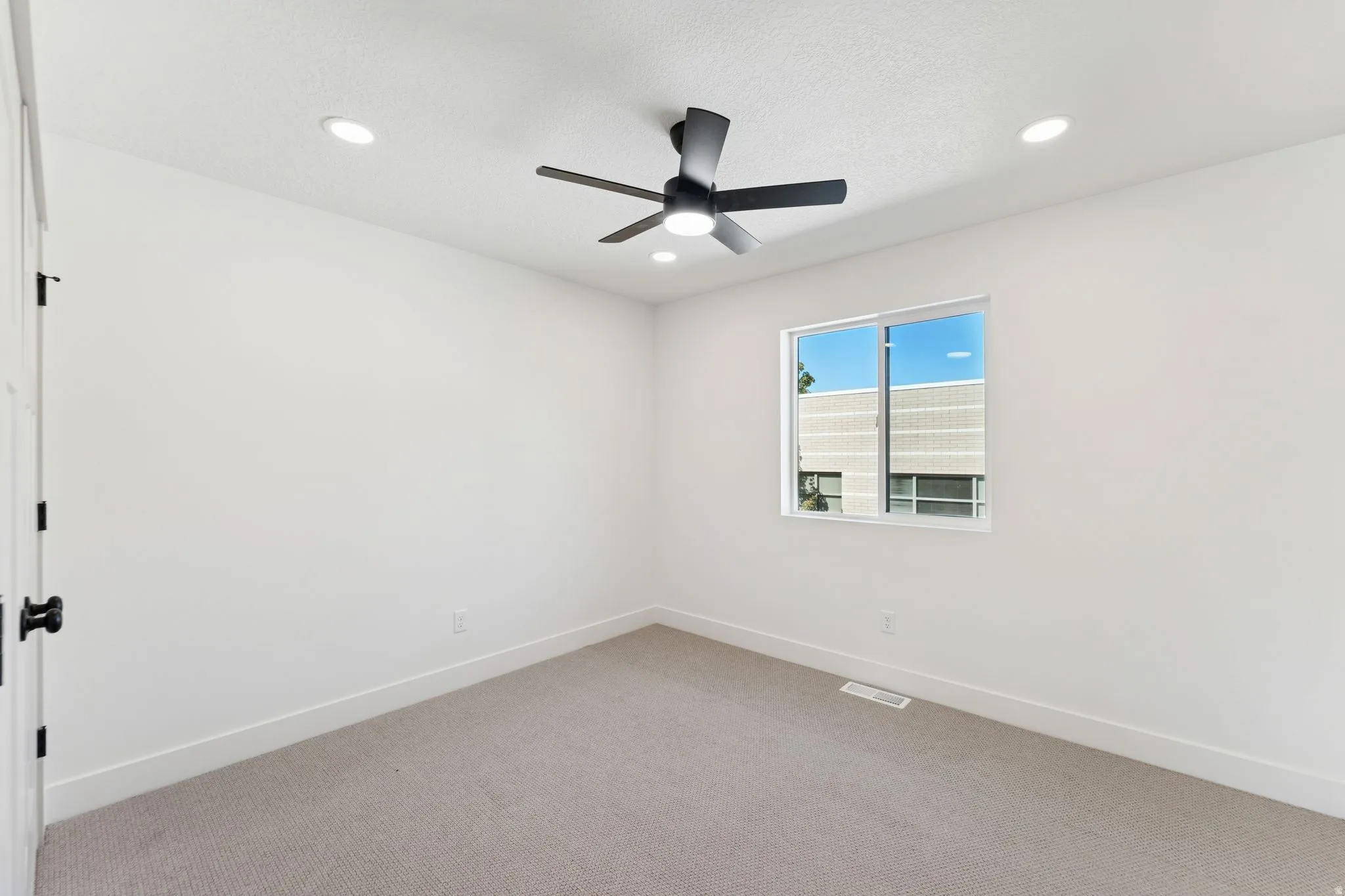 Unfurnished room with light carpet, recessed lighting, and a ceiling fan