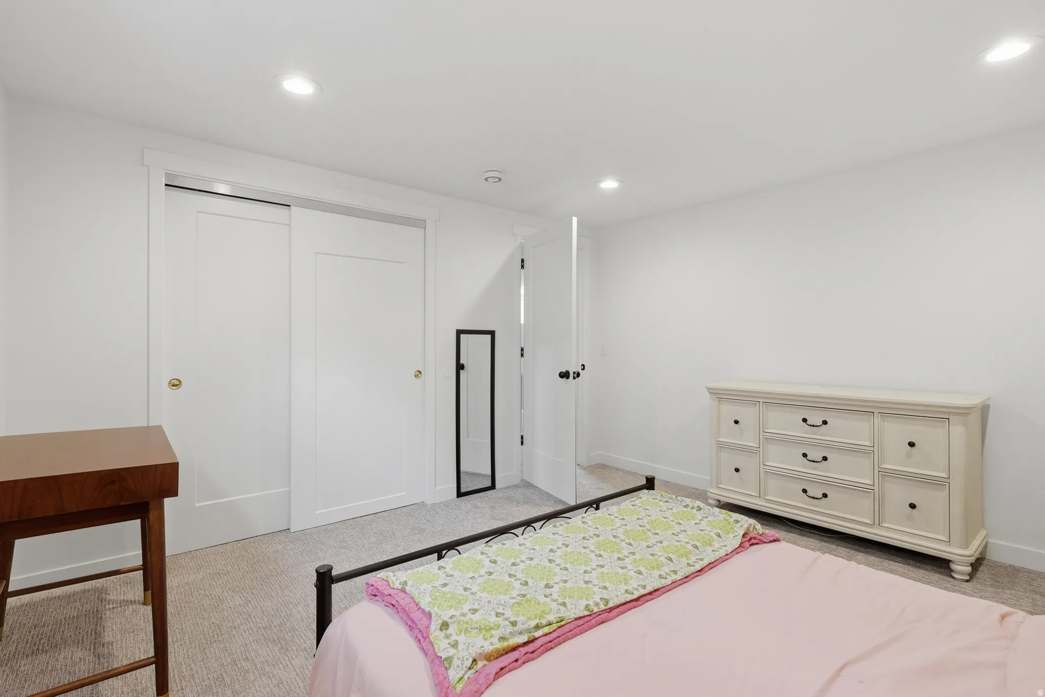 Bedroom featuring light colored carpet, a closet, and recessed lighting