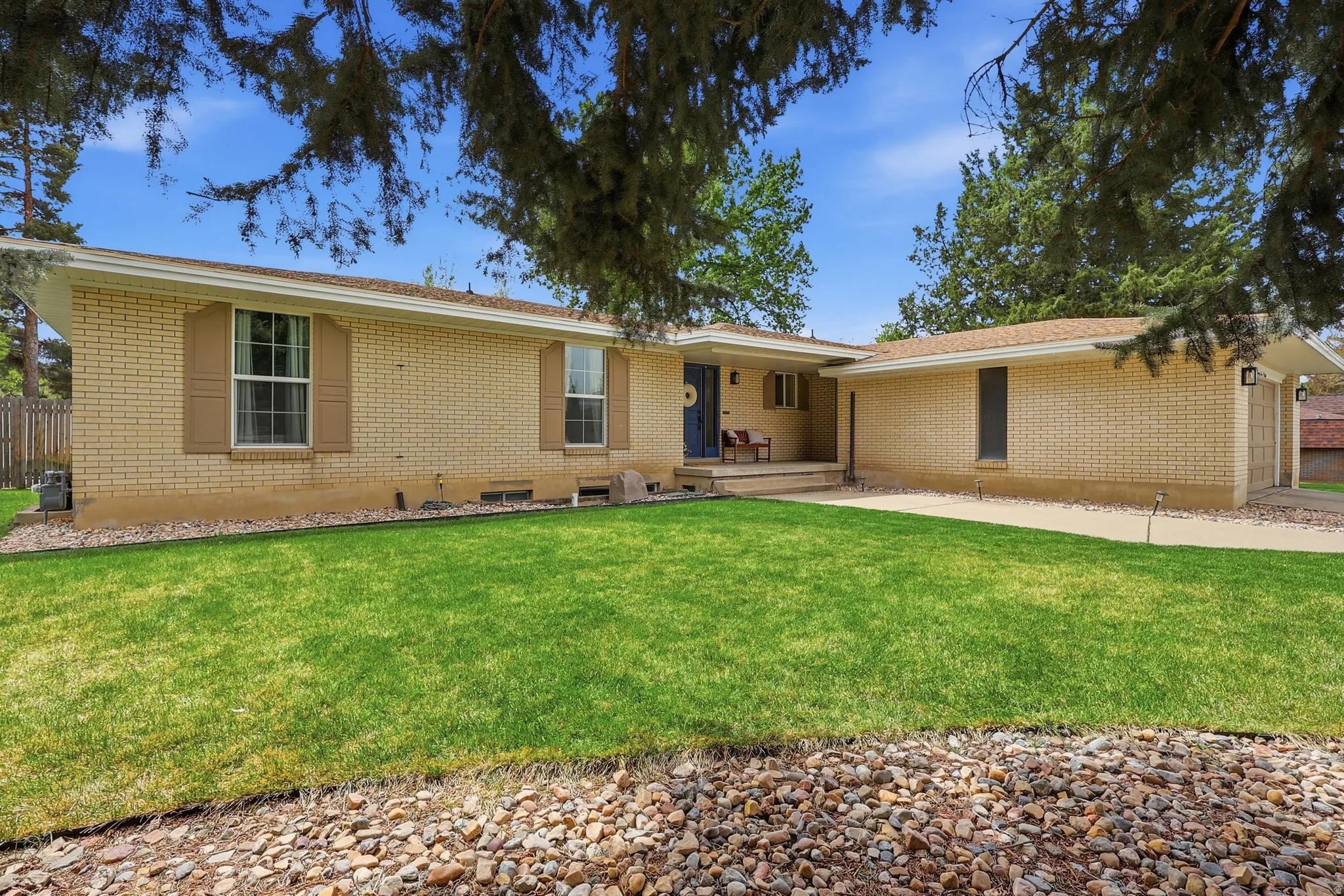 Ranch-style home featuring brick siding and a front lawn