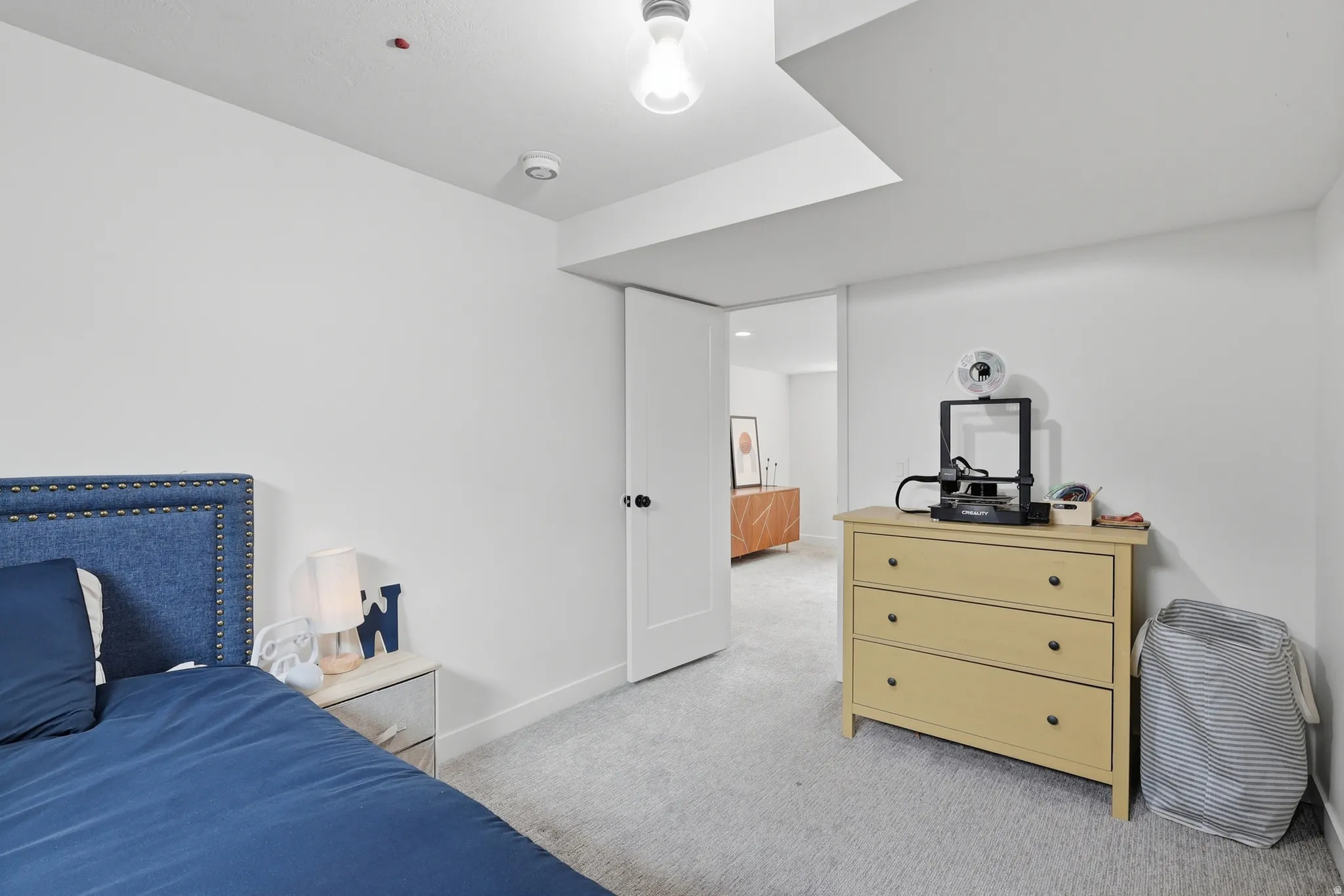 Bedroom with light carpet and baseboards