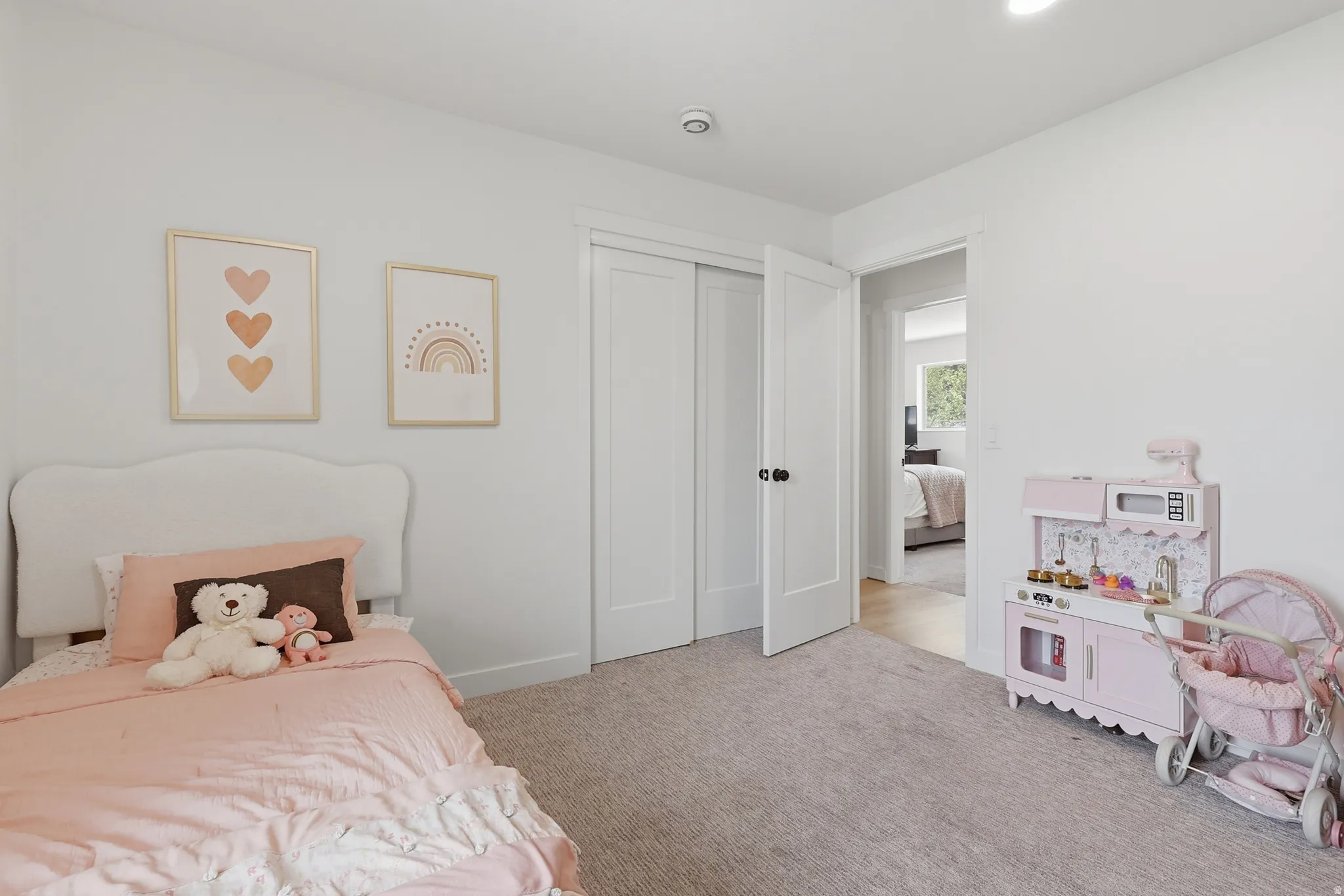 Carpeted bedroom with a closet and baseboards