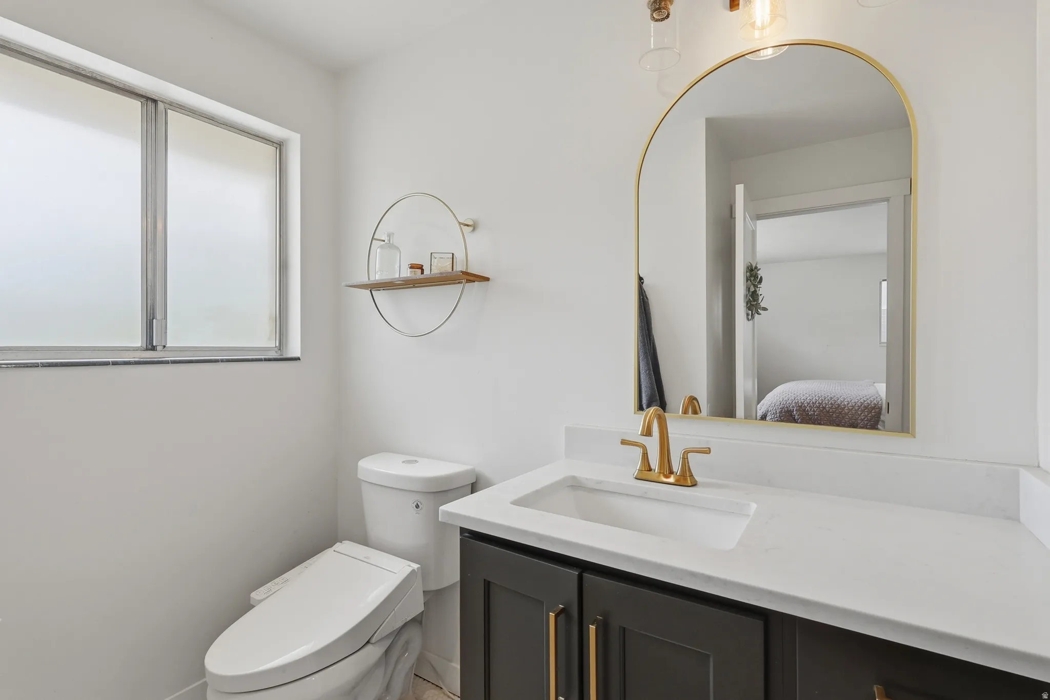 Half bathroom with vanity and ensuite bath