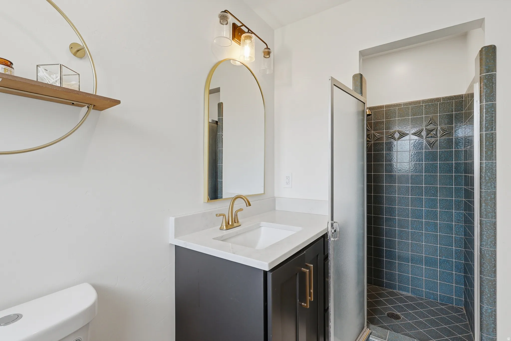 Bathroom with a stall shower and vanity