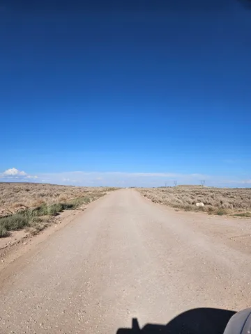View of dirt / gravel road with a view of countryside