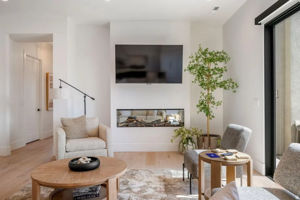 Living area with light wood-style flooring and baseboards