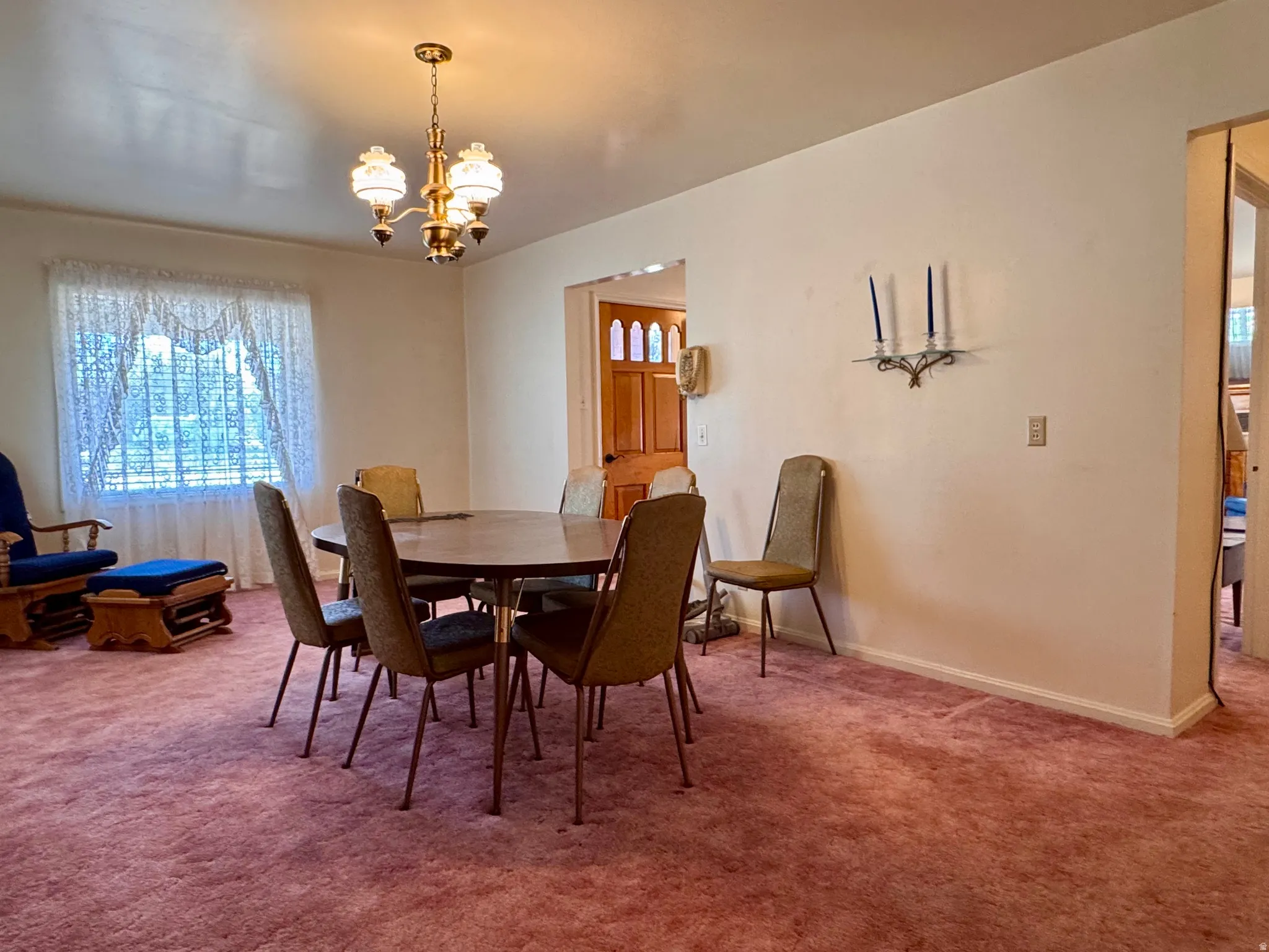 Dining room featuring carpet and suspended lighting