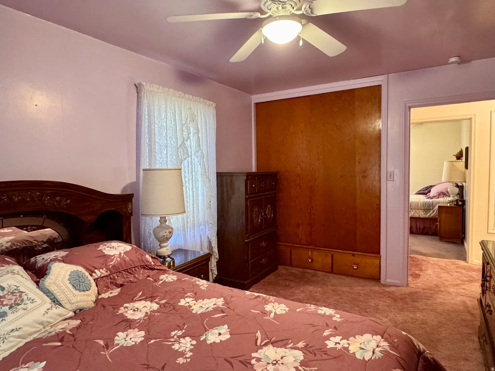 Bedroom featuring a ceiling fan, carpet flooring, and a closet
