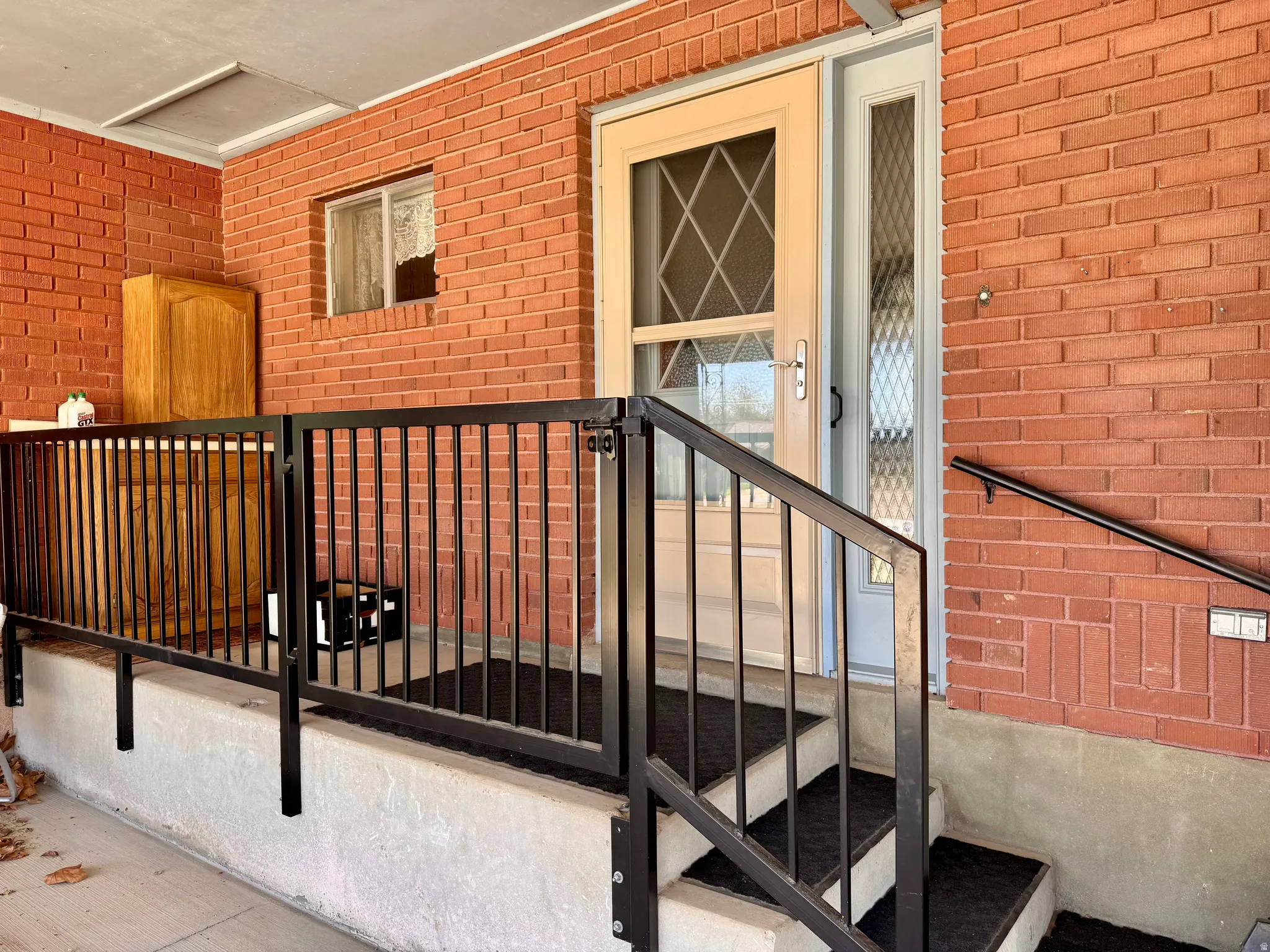 Entrance to property featuring brick siding