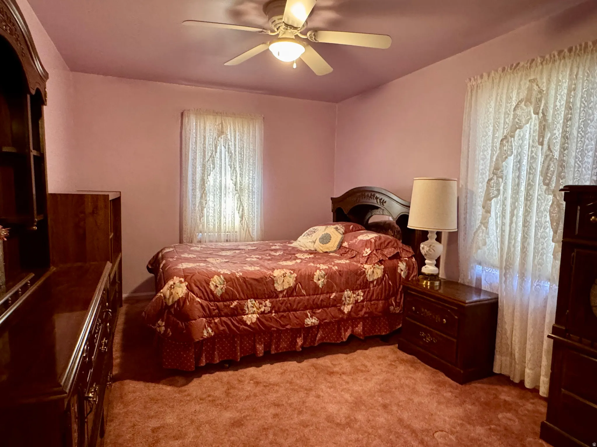 Bedroom with light carpet and ceiling fan