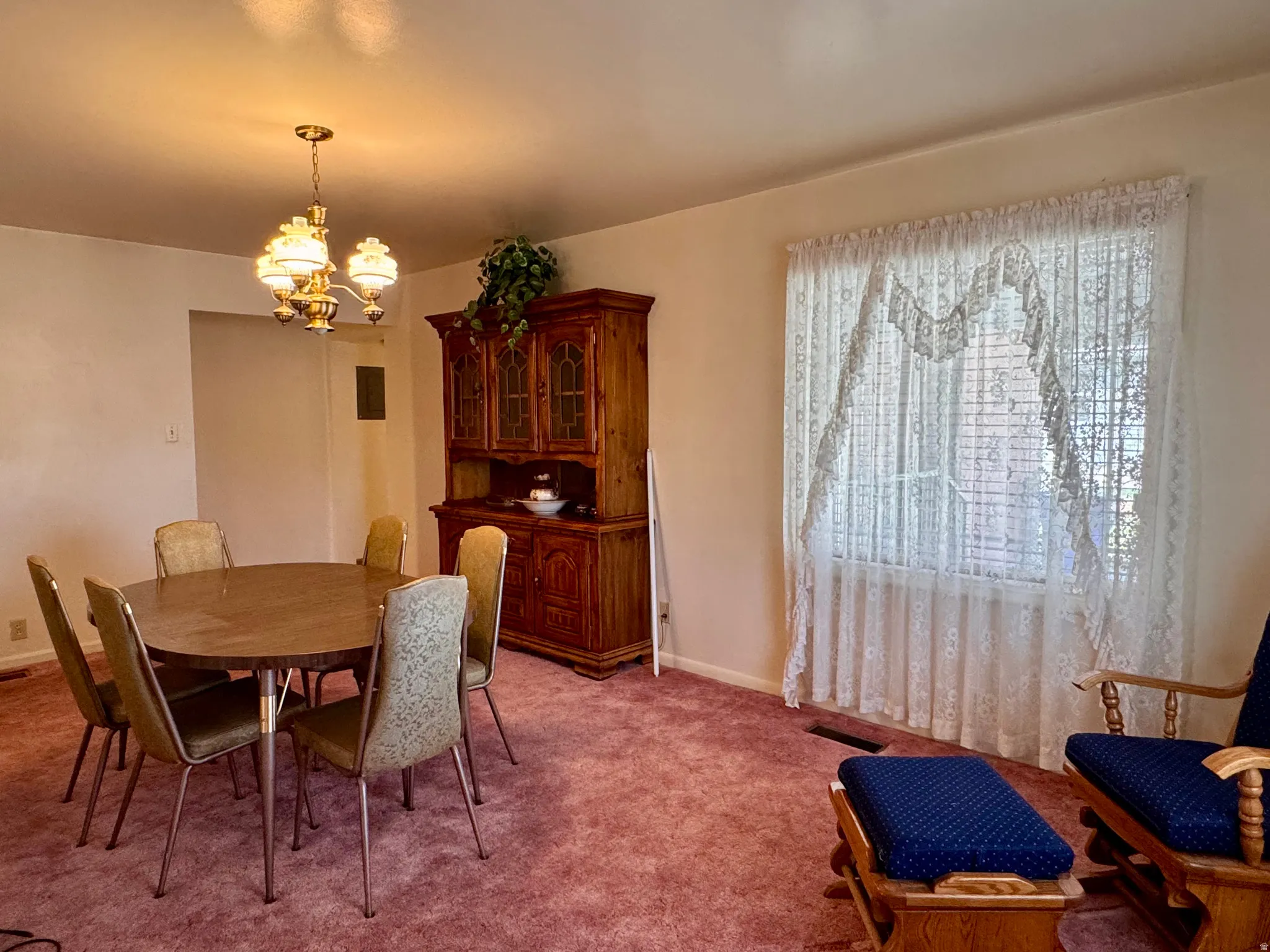 Dining space featuring light carpet and hanging lights