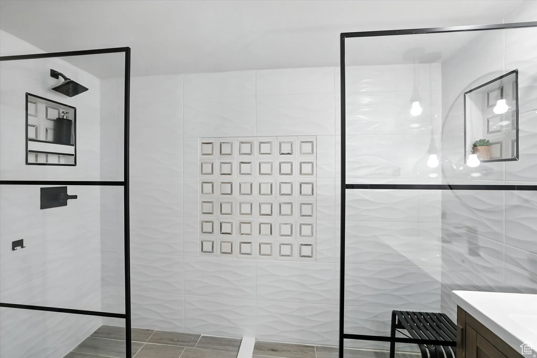 Bathroom suite with tile walls, vanity, and a walk in shower