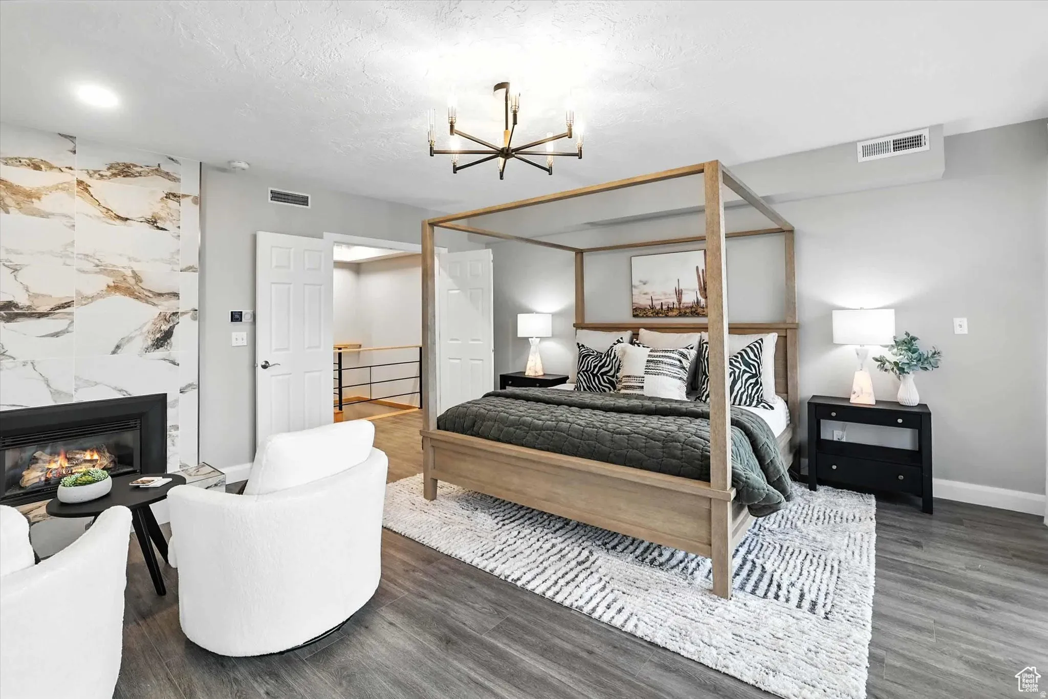 Top floor bedroom suite with a chandelier, and a premium gas fireplace