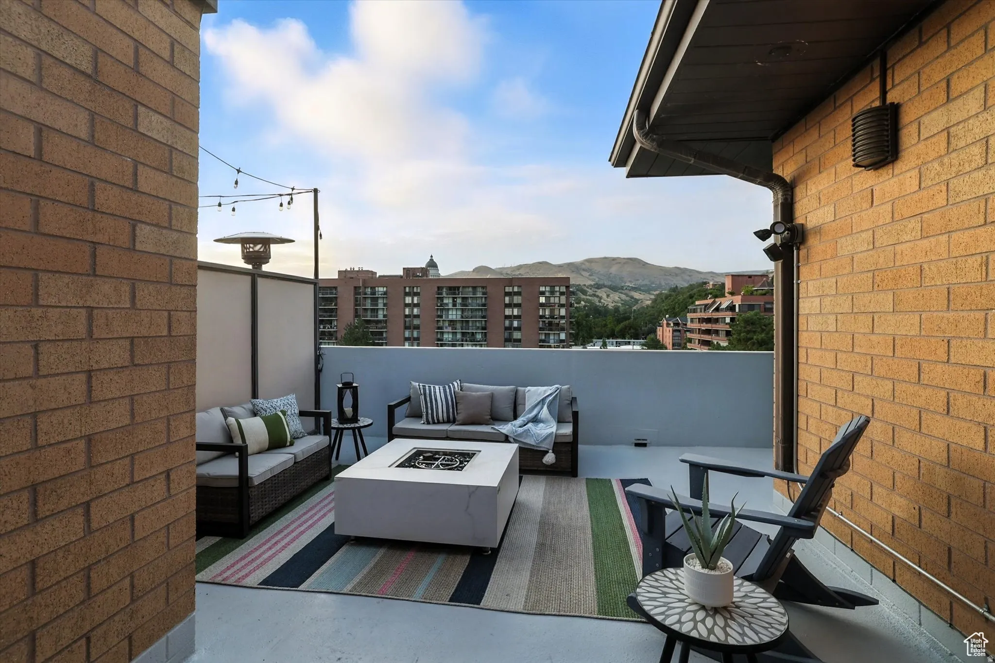 Balcony with an outdoor living space with a fire pit and a mountain view