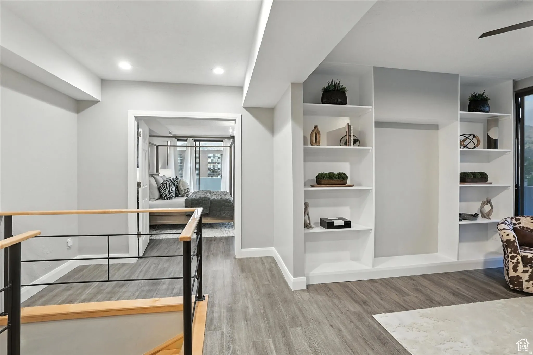 Top of stairs leading to an open office space