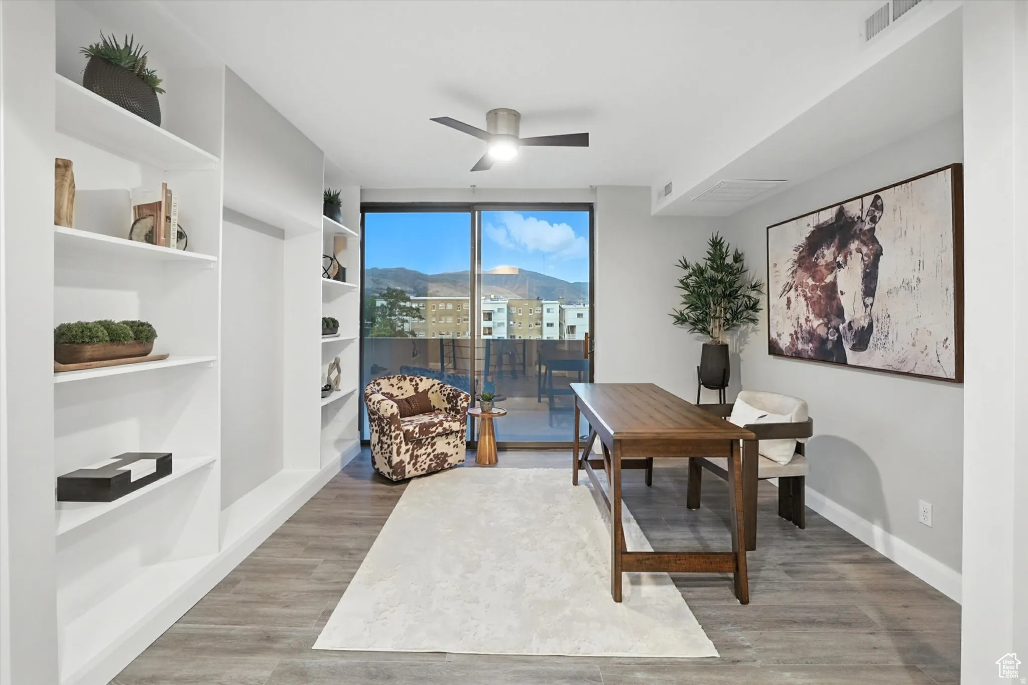 Home office with a built in shelves, and a mountain view with access to the roof top deck