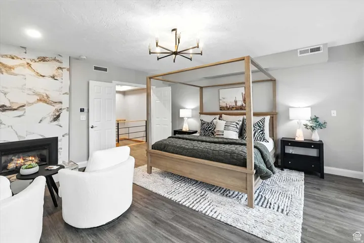 Top floor bedroom suite with a chandelier, and a premium gas fireplace