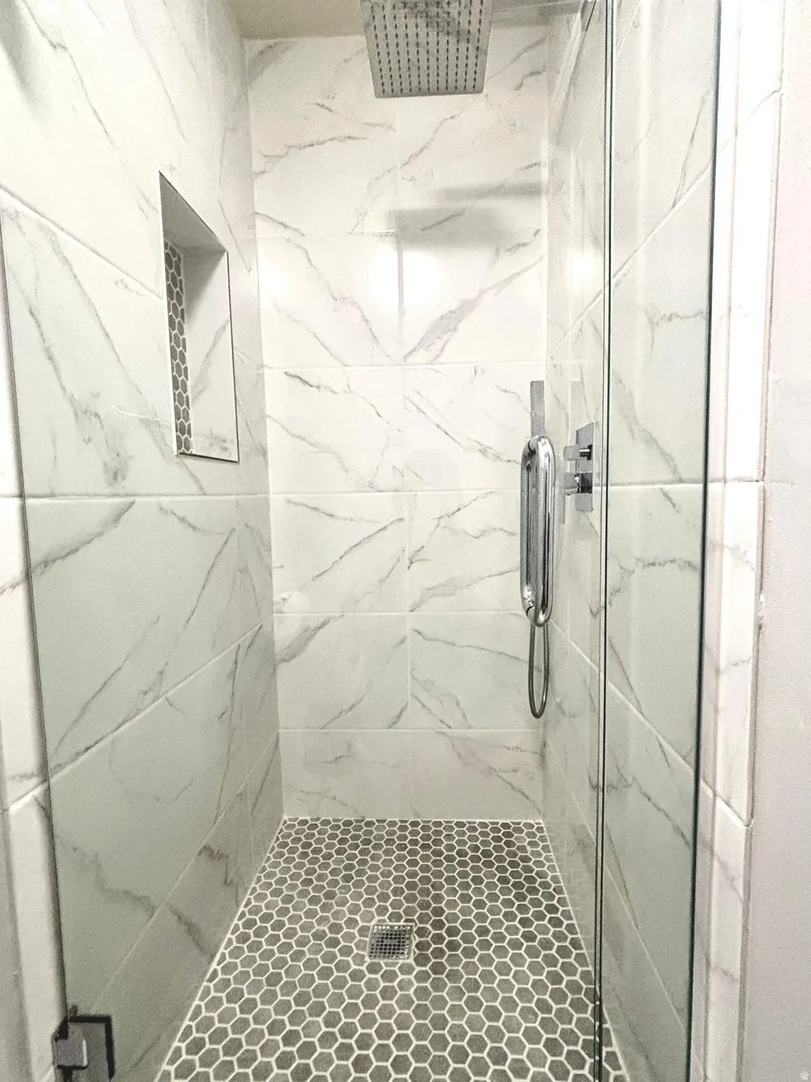 Bathroom featuring a marble finish shower