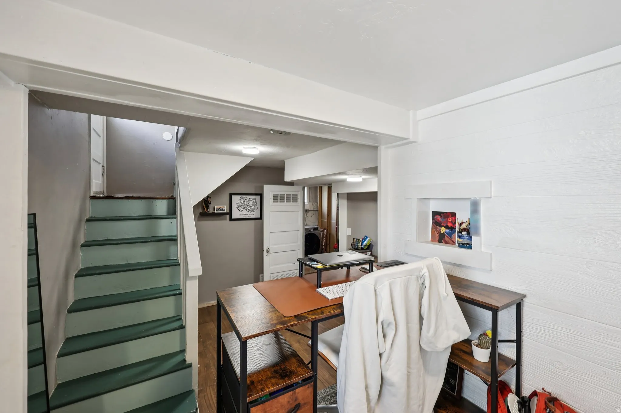 Dining space with stairway and wood finished floors