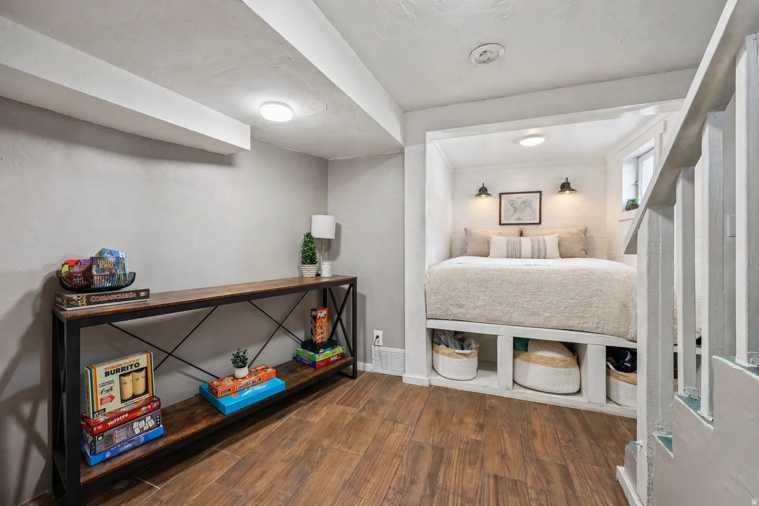 Bedroom with dark wood finished floors and baseboards