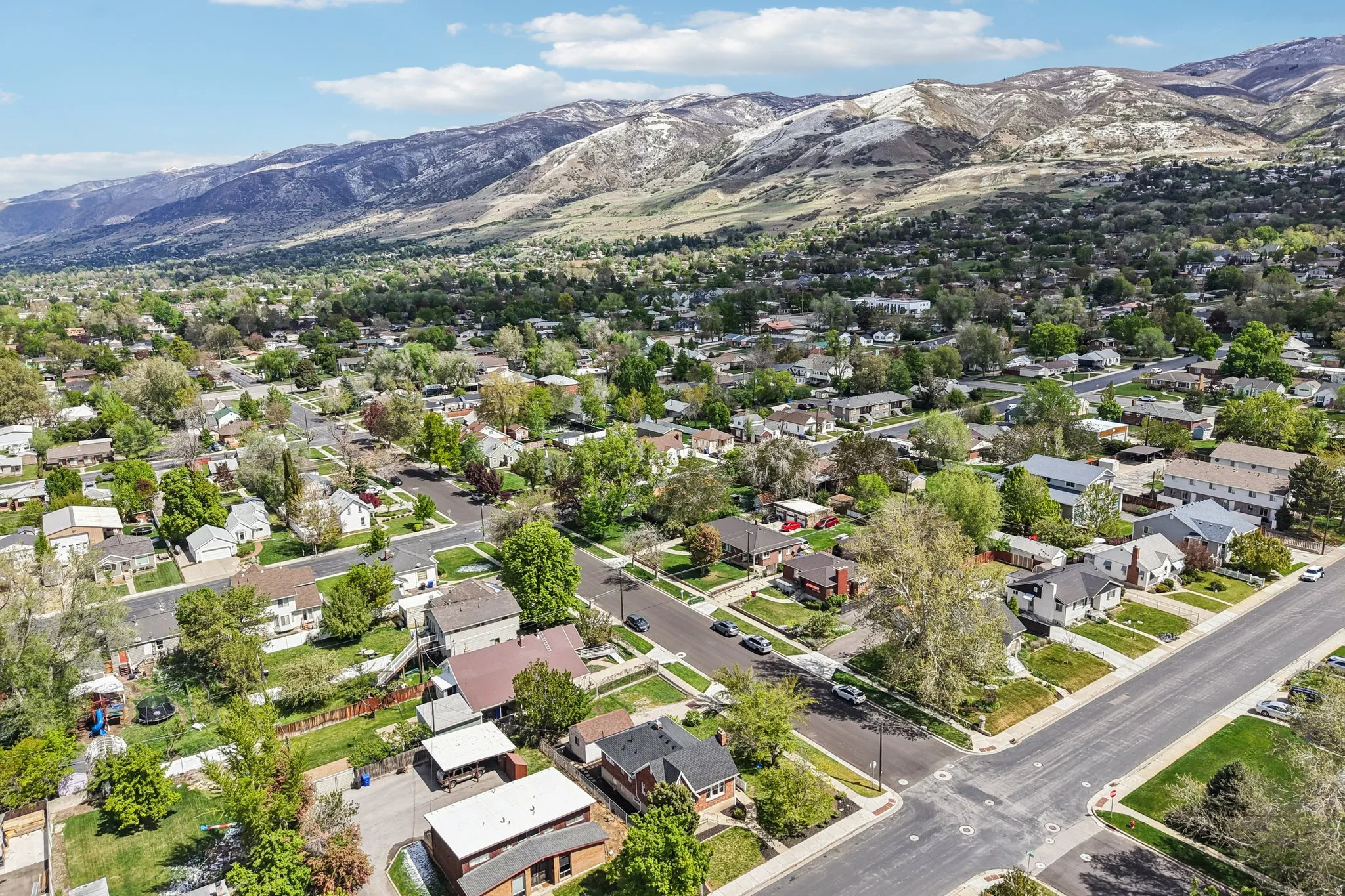 Aerial perspective of suburban area featuring a mountainous background