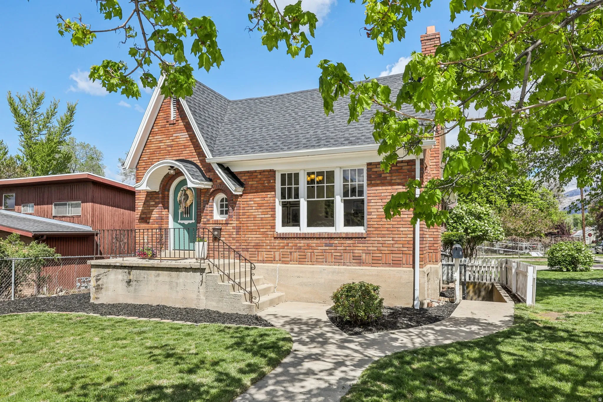 View of front of property featuring brick siding and a shingled roof