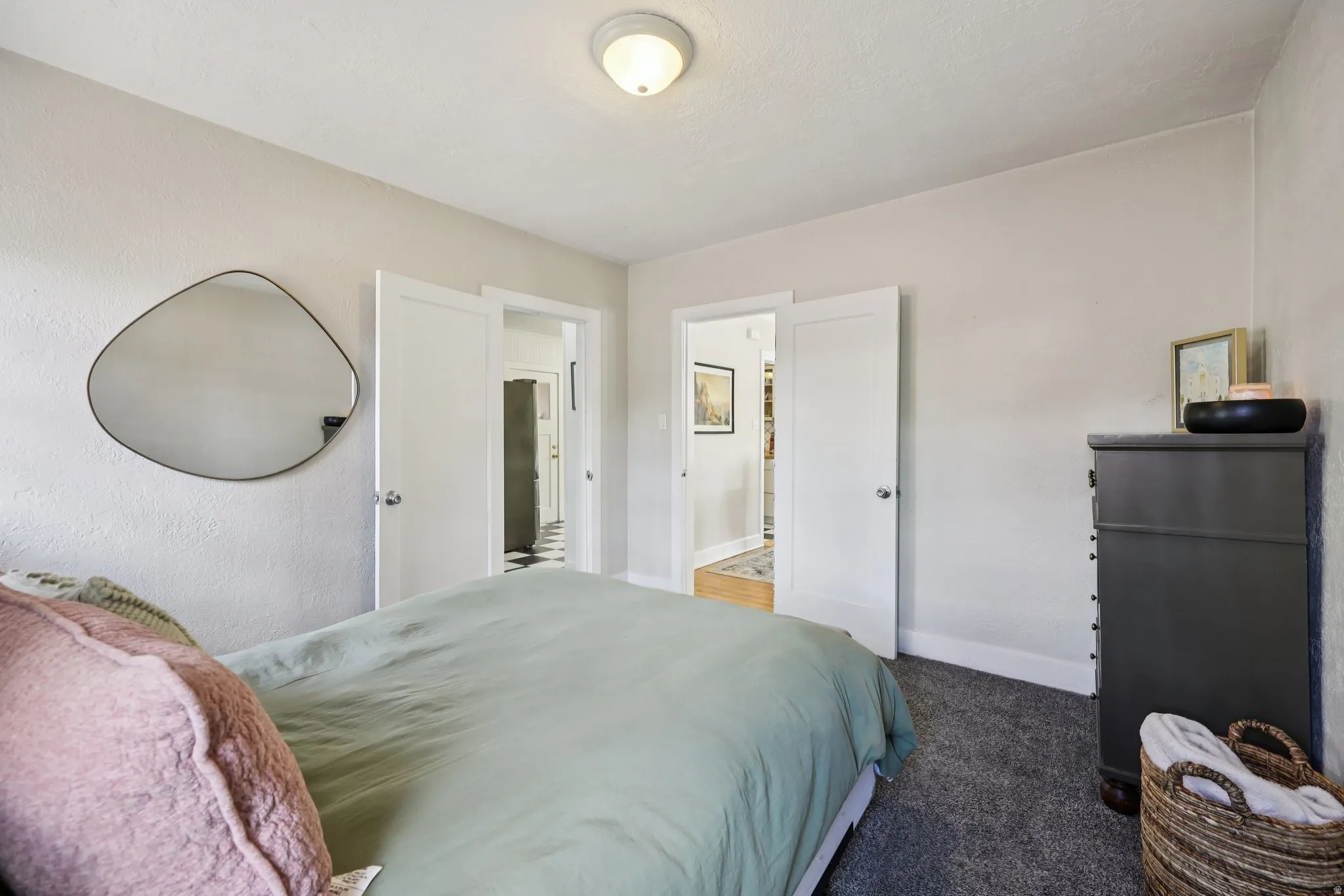 Bedroom with dark carpet and baseboards