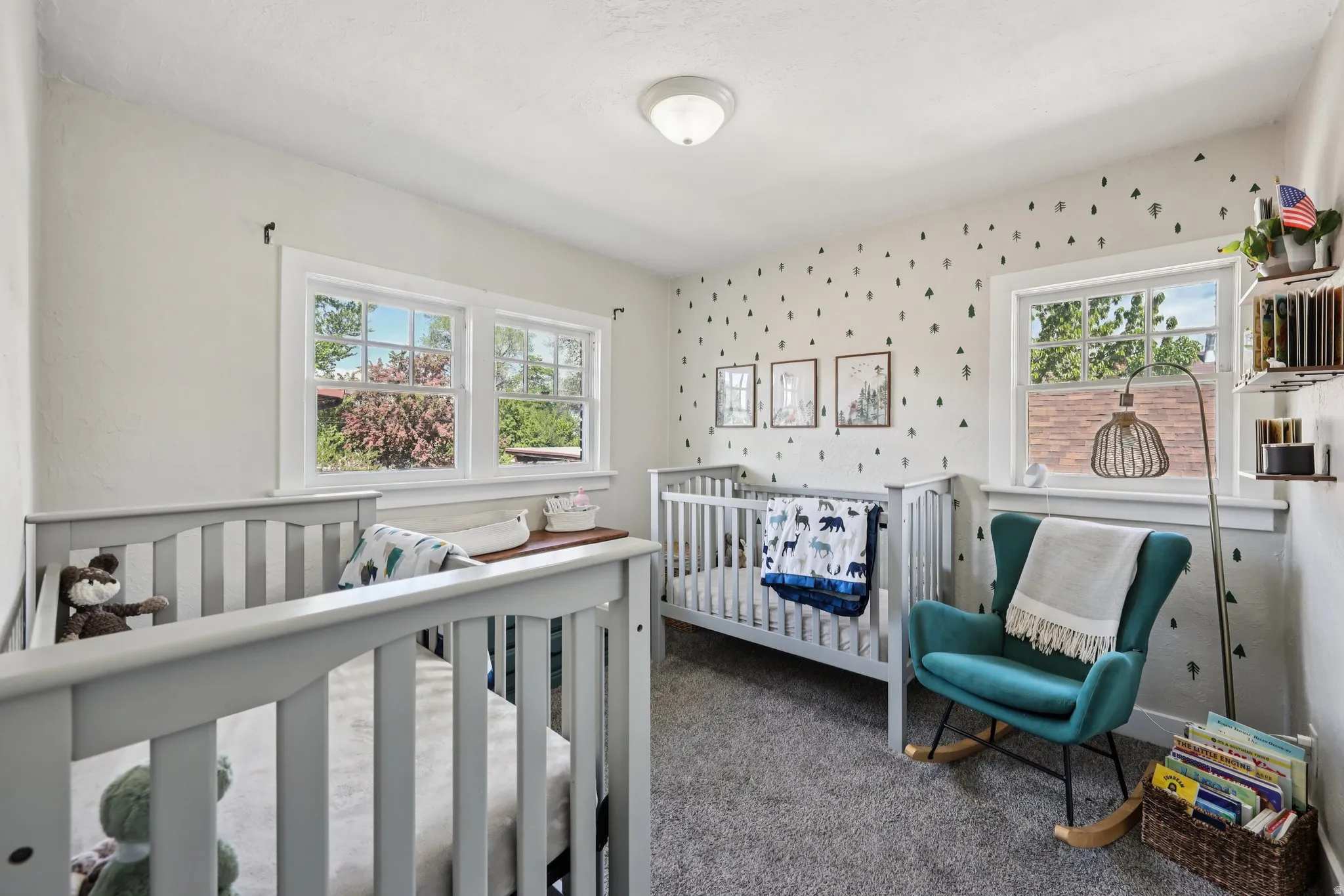 Bedroom featuring wallpapered walls, carpet, and a crib