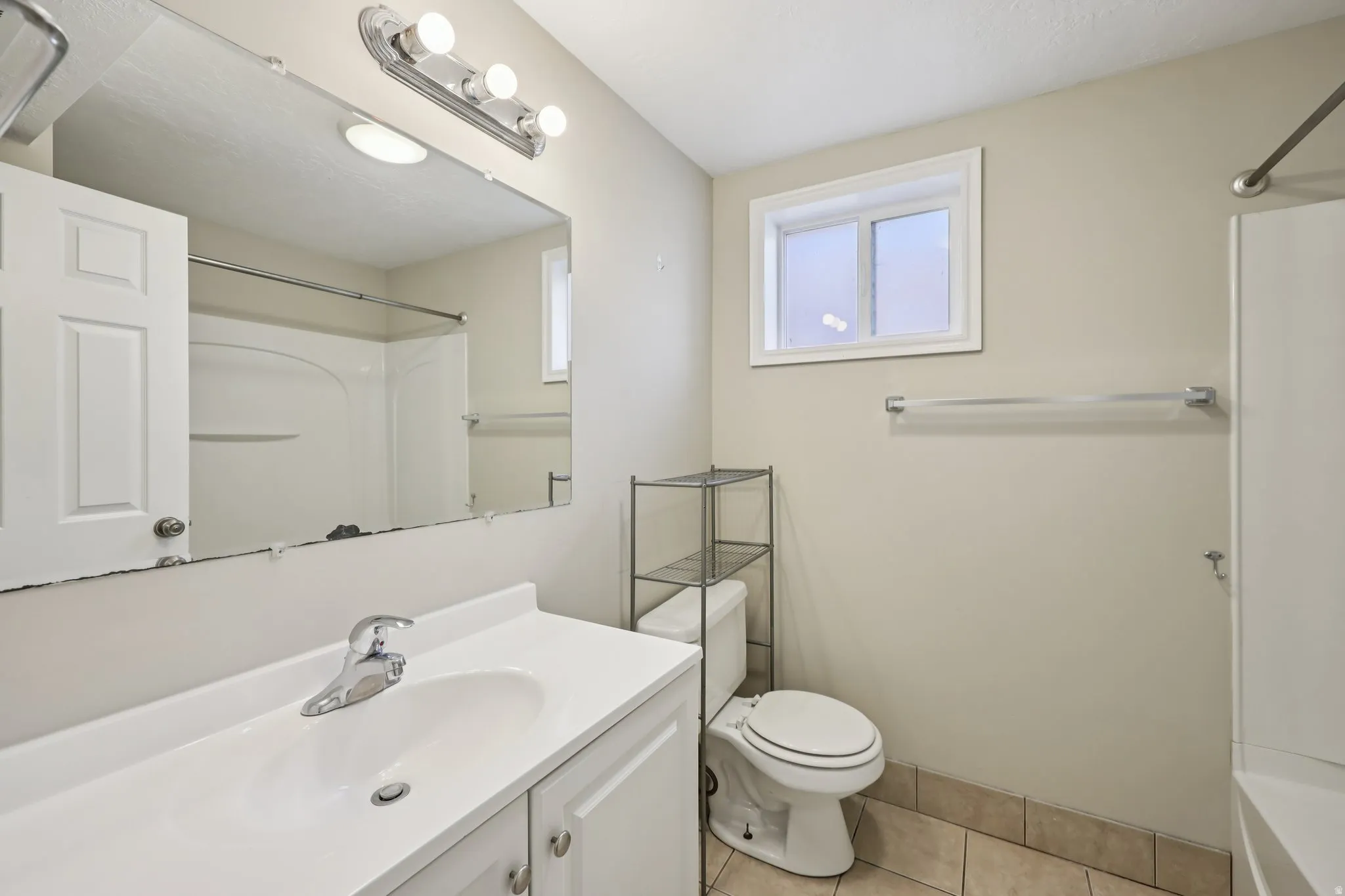 Bathroom featuring vanity and light tile patterned flooring