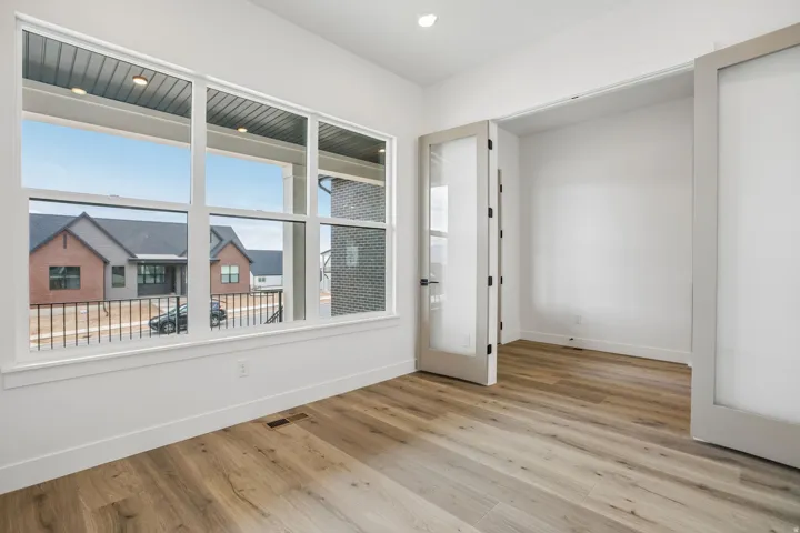 Wood-finish flooring, recessed lighting, and a large multi-pane window