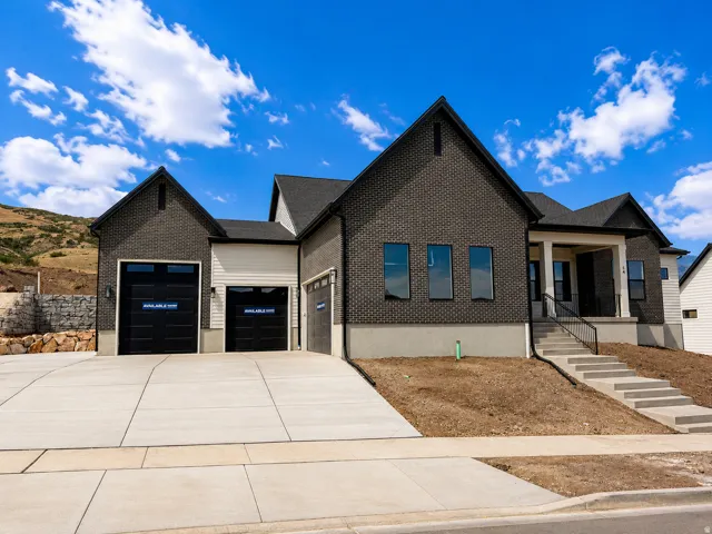 Modern residence featuring dark brick and light siding exterior accents
