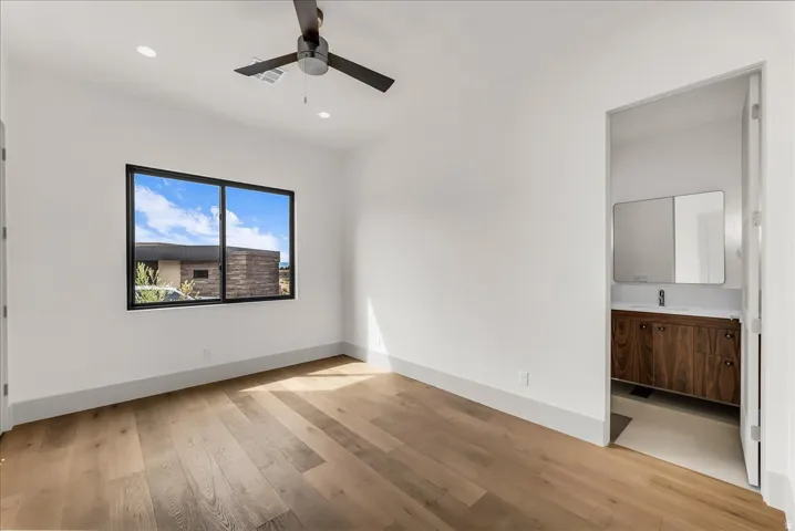 Wood-finish flooring, recessed lighting, and a ceiling fan