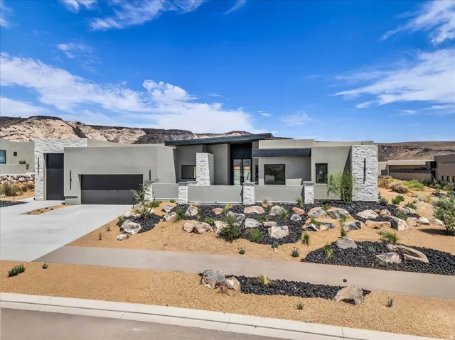 Modern architectural residence featuring a flat roofline and integrated garage