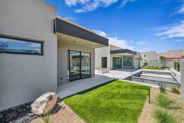 Modern exterior architecture featuring a stucco finish and black trim accents