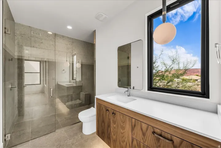 Floating wood-finish vanity with an integrated sink and white countertop