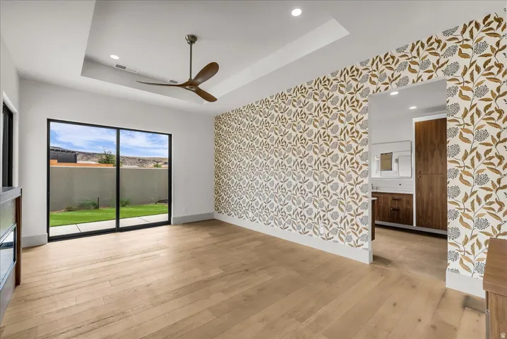 Wood-finish flooring, recessed ceiling lighting, and a modern ceiling fan