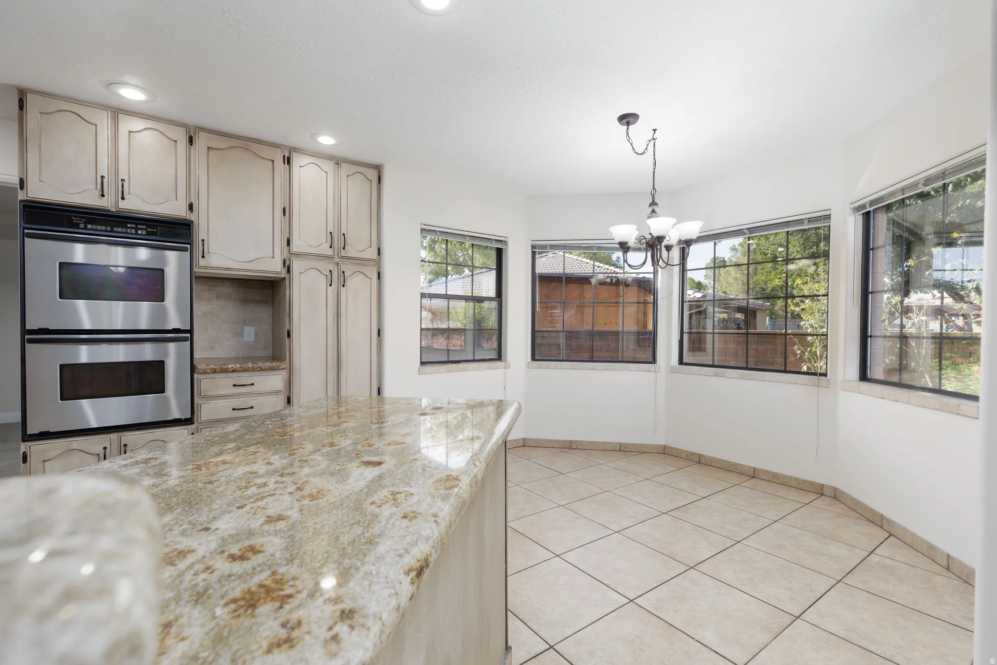 Kitchen with light-toned cabinetry and stainless steel double ovens
