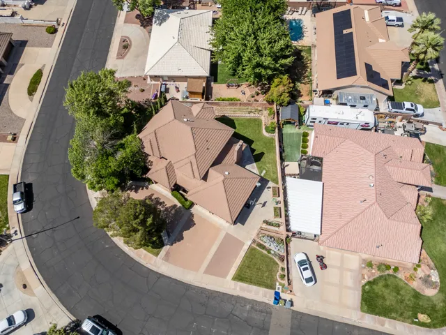 Expansive property featuring a curved driveway, mature landscaping, and a multi-level roofline